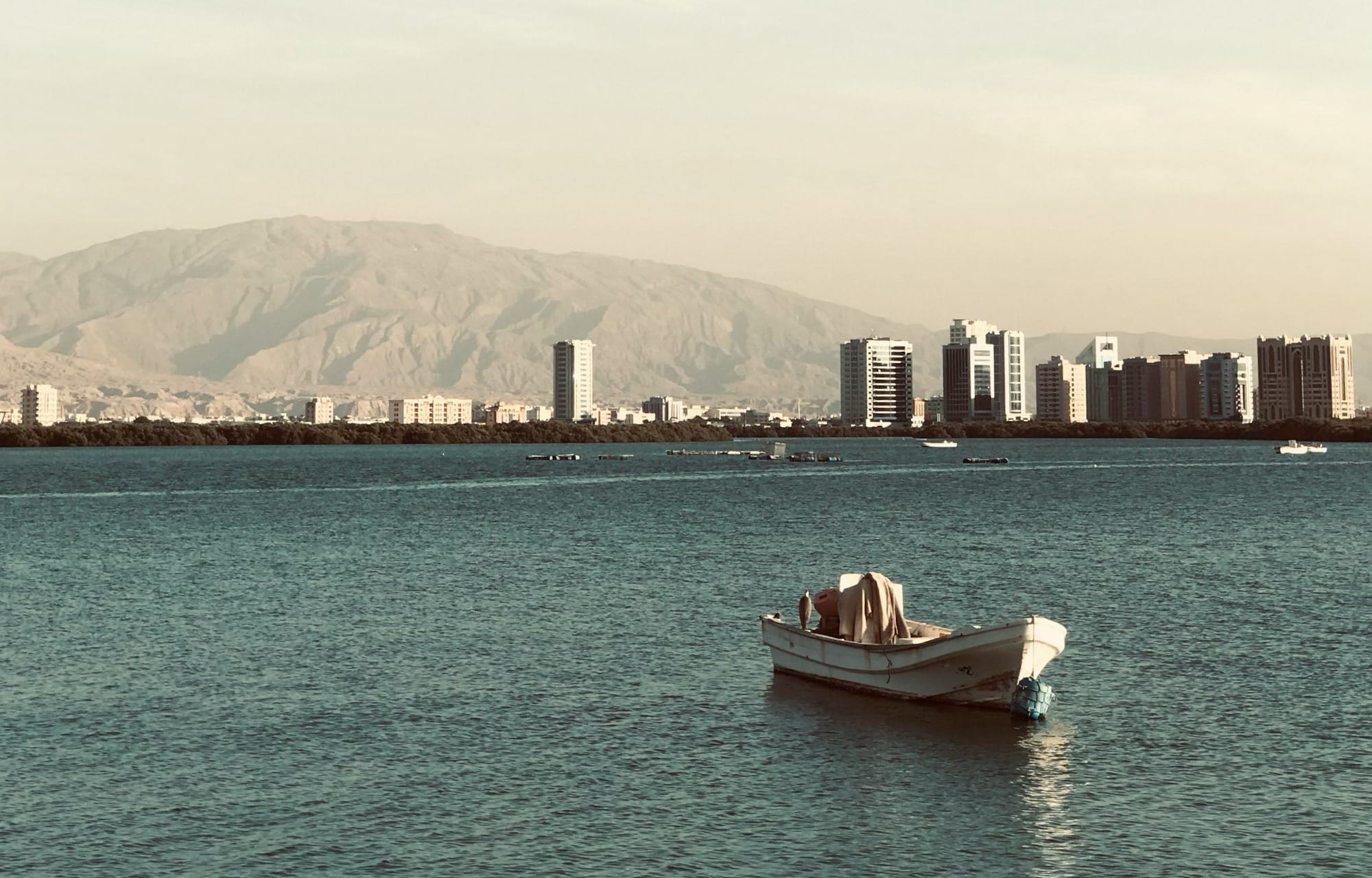 a small boat floating on top of a large body of water